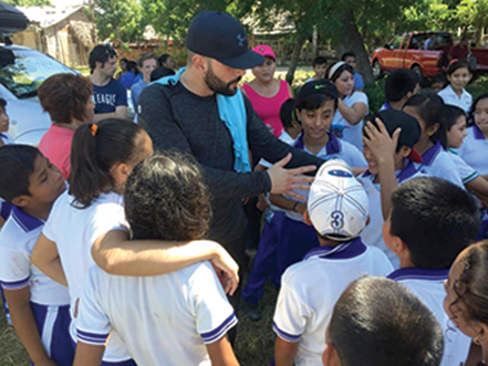Jaime entertains local children while visiting the safe water system.