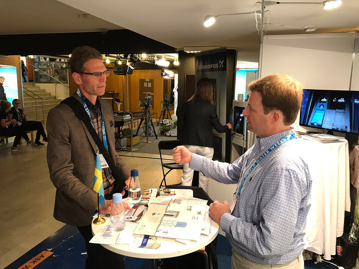 George Greene, PE speaks with an interested SIWI attendant at World Water Week.