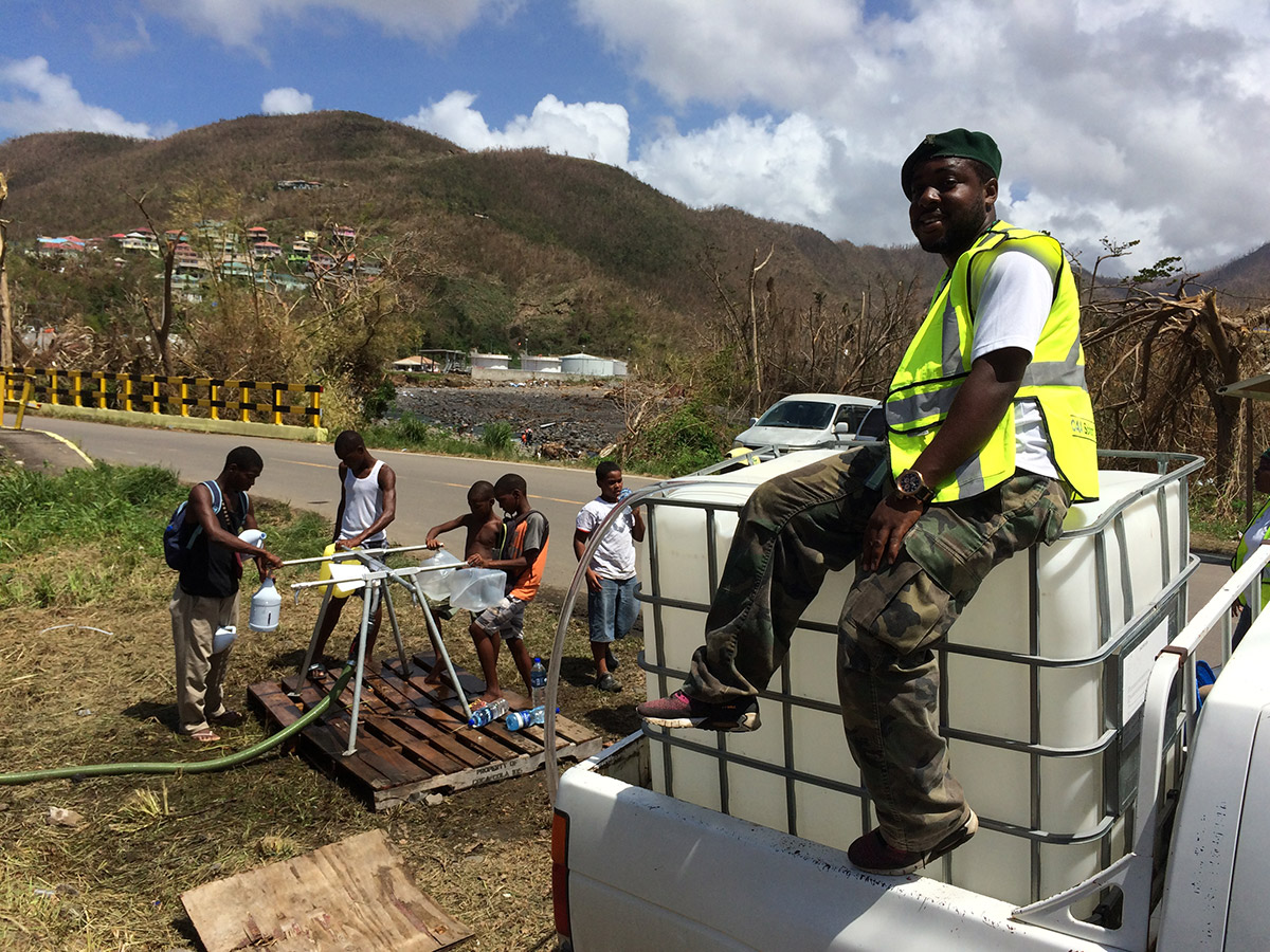 The safe water treatment system operator observes as safe water is distributed.