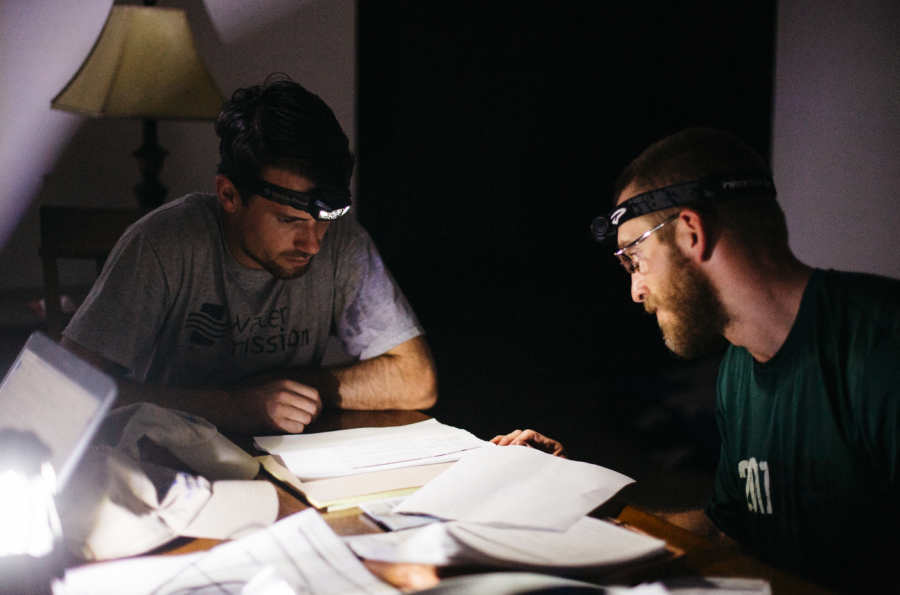 Sean McSwain (Project Manager) and Michael Steele (Field Engineer) work late at night without power.