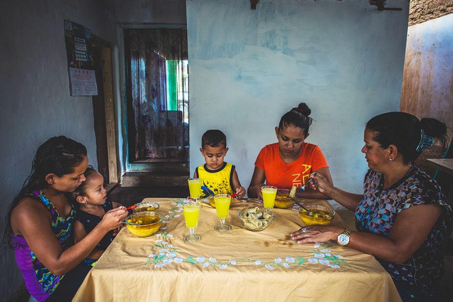 Ubelia and her family enjoy a meal together.