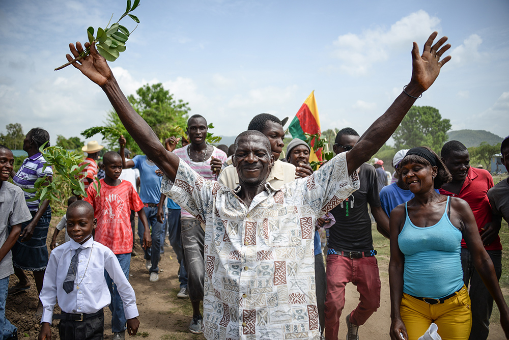 A man in Haiti celebrates the commissioning of a safe water project in his community.