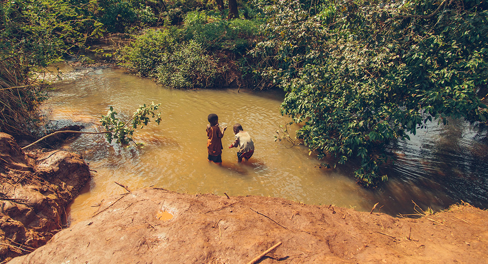 Before their community had safe water, children in this Tanzanian community gathered dirty, unsafe water for their families.