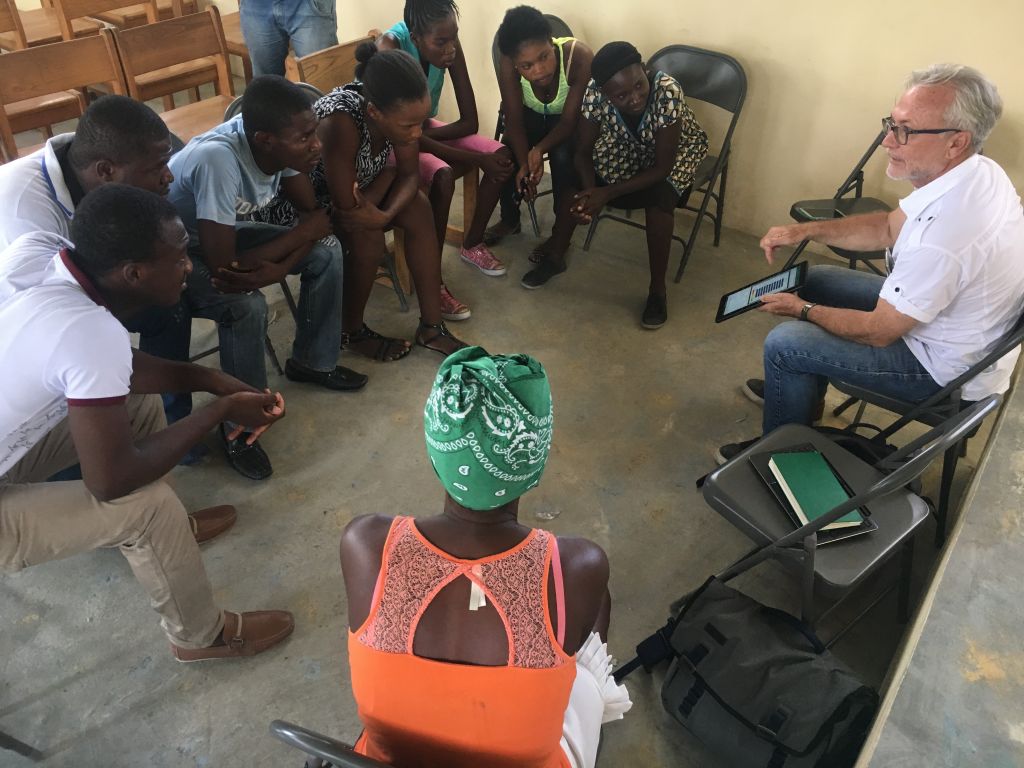 Survey participants in Haiti learn the results of the survey they've taken.