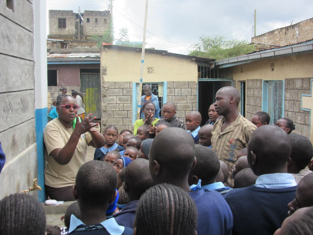 Students gather to learn handwashing.