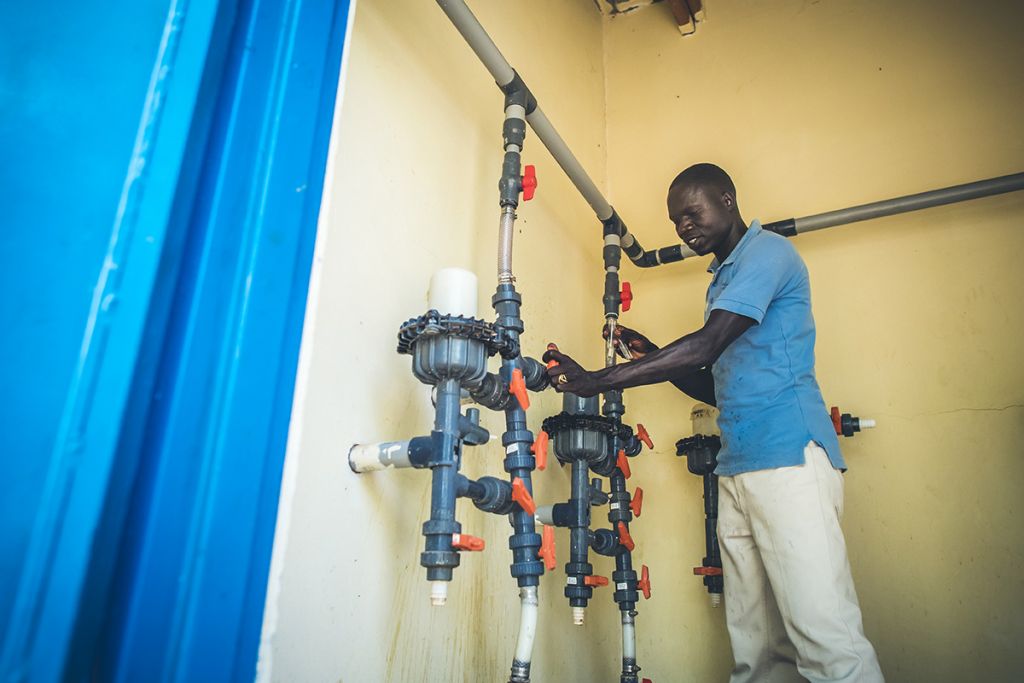 Water Mission Uganda technician making repairs to a water system.