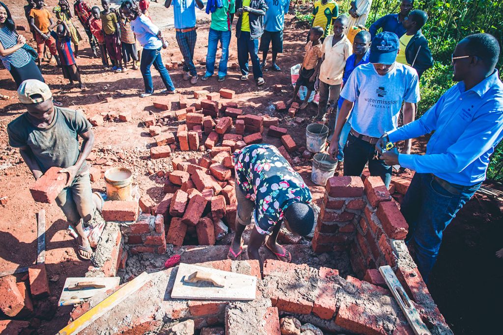 Residents of Zeze helping to construct a safe water system