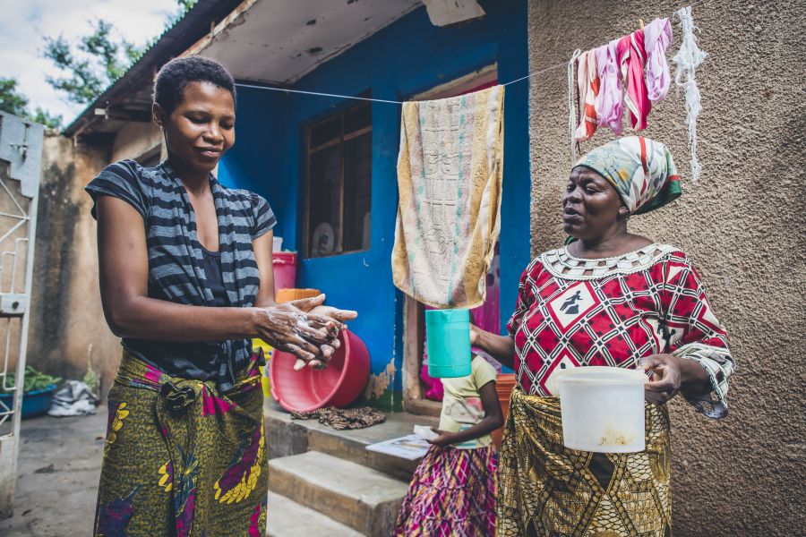 Women in Kiruru, Tanzania practice how to properly wash hands to improve sanitation conditions and the overall health of the community. Taken by Sean Sheridan, for Water Mission.