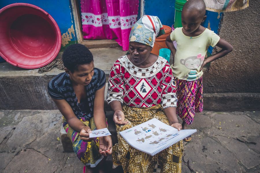 Jaina Iddi Mwenda, WASH Coordinator for Water Mission, teaches her community the best methods for sanitation and hygiene. Taken by Sean Sheridan, for Water Mission.